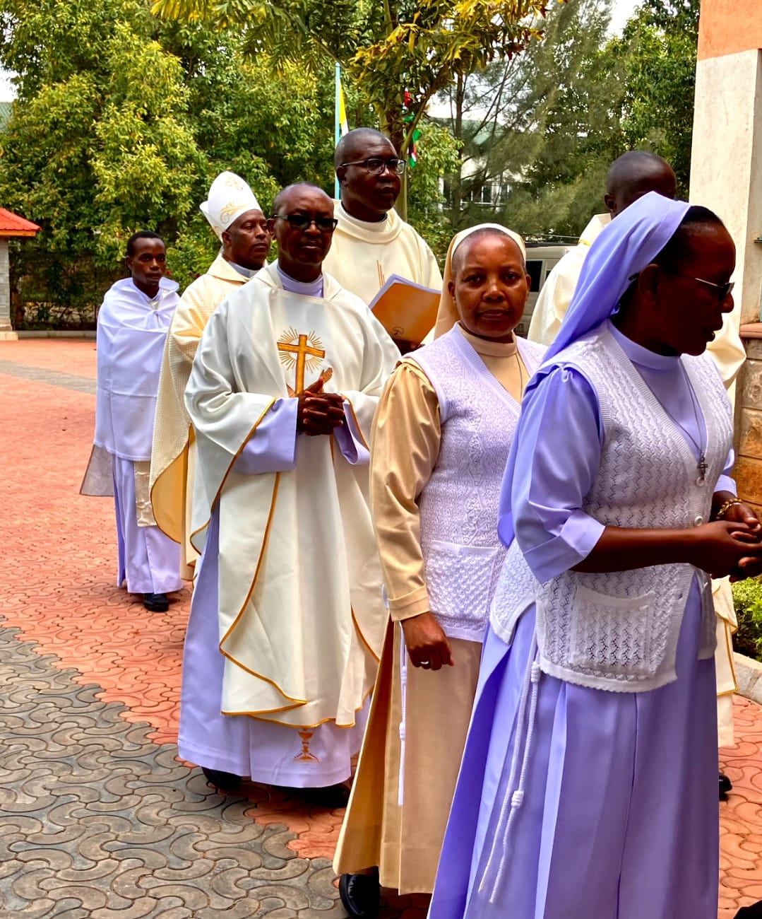 Clergy and sisters in procession during a college celebration