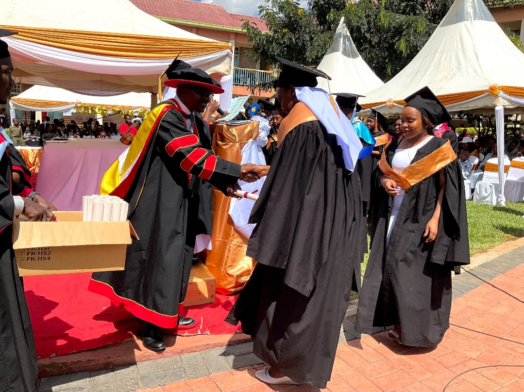 A graduand receiving her certificate during the graduation ceremony